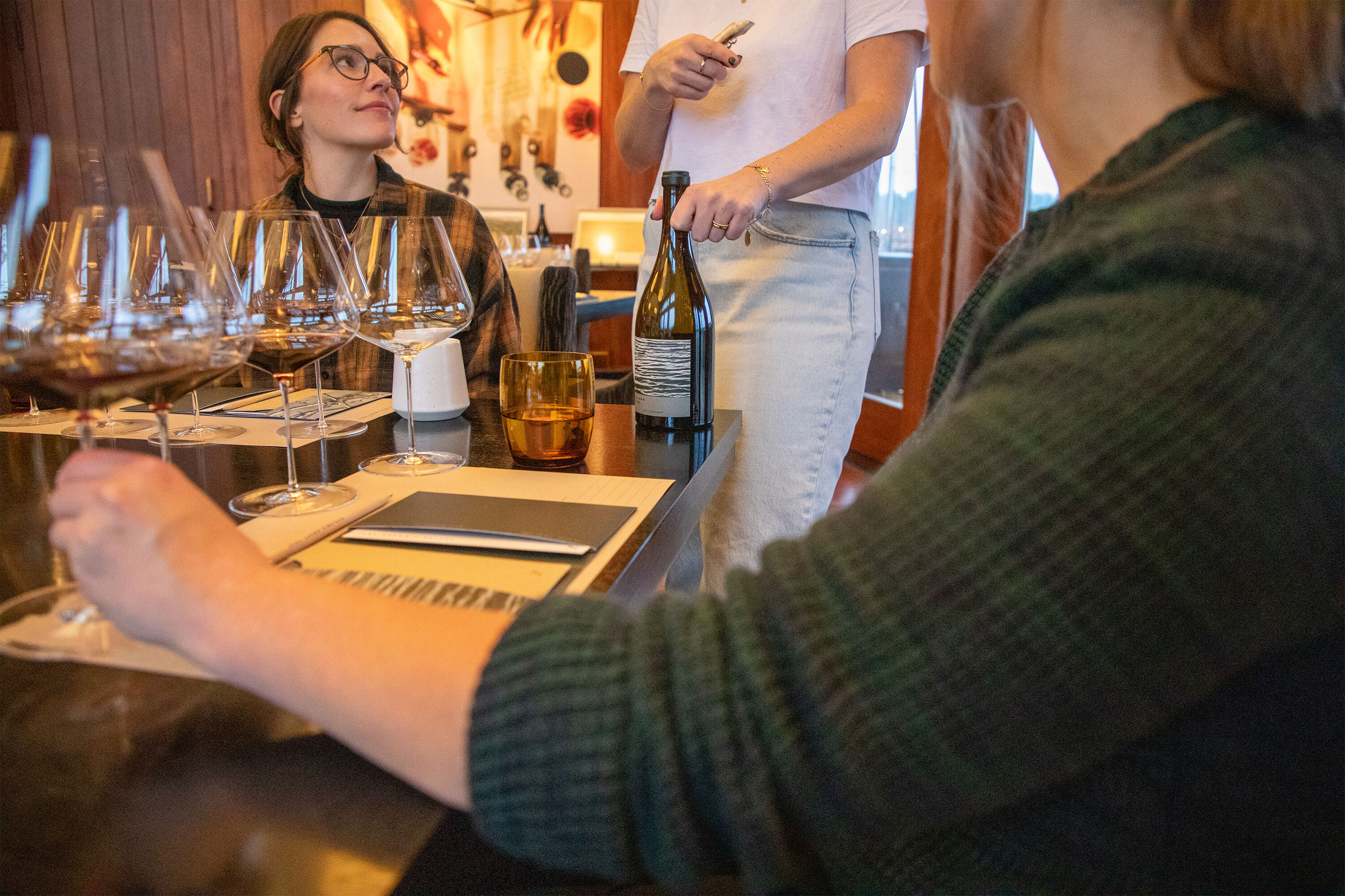 Two women enjoying Zena Crown Experience tasting at Gran Moraine.